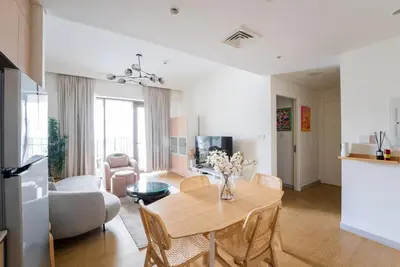 a living room with a table and a couch at Stylish Beachfront Creek Escape in Dubai