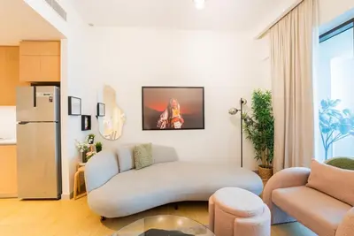 a living room with a couch and a chair at Stylish Beachfront Creek Escape in Dubai