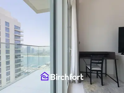 a room with a desk and a balcony with a view at Spacious 3,5 BHK with Amazing View in Dubai