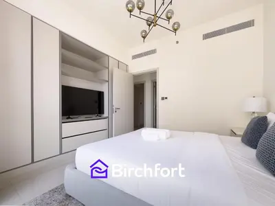 a white bedroom with a bed and a tv at Spacious 3,5 BHK with Amazing View in Dubai