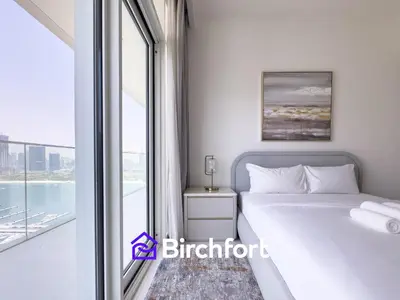 a bedroom with a bed and a large window at Spacious 3,5 BHK with Amazing View in Dubai
