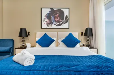 a bedroom with a blue and white bed with blue pillows at White Sage Damac Hills Cozy Artesia Studio in Dubai