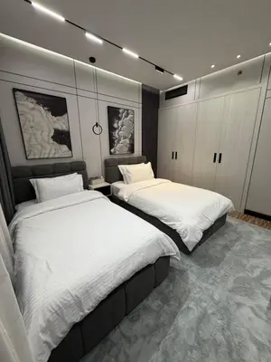 two beds in a room with white sheets at TOP VIEW Luxury 2 bedrooms in Dubai only families in Dubai