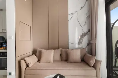 a living room with a couch and a painting on the wall at Zarela Luxe with River Views in Dubai