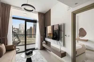 a living room with a couch and a large window at Zarela Luxe with River Views in Dubai