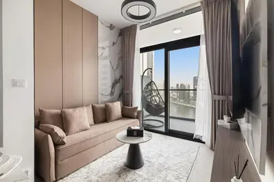 a living room with a couch and a large window at Zarela Luxe with River Views in Dubai