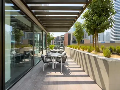 a balcony with a table and chairs on a building at GuestReady - 1BR l Canal View | Near Dubai Mall in Dubai