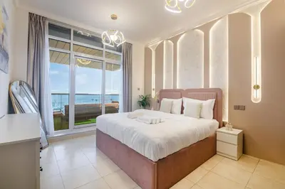 a bedroom with a large bed and a large window at Luxury 3 BHK High Floor Pool, Gym Sauna Opal 2705 in Dubai