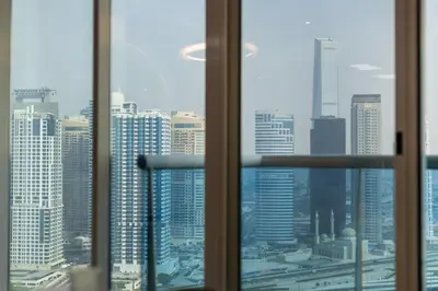 a view of a city skyline from a window at Luxury 3 BHK High Floor Pool, Gym Sauna Opal 2705 in Dubai