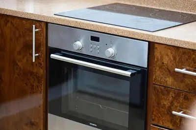 a stove top oven sitting in a kitchen at Luxury 3 BHK High Floor Pool, Gym Sauna Opal 2705 in Dubai