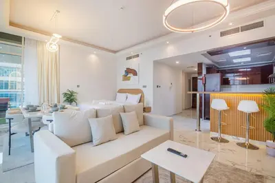 a living room with a white couch and a table at Luxury 3 BHK High Floor Pool, Gym Sauna Opal 2705 in Dubai