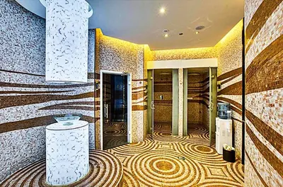 a lobby with a large room with a spiral tile floor at Mayfair Luxury Apartment in 5-Star DAMAC Maison Mall Street Building, Downtown Dubai in Dubai