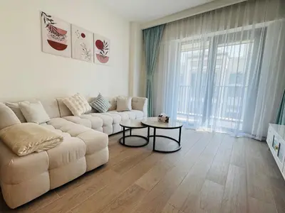 a living room with a couch and a table at Apartment In Creek Beach in Dubai