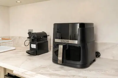 a microwave sitting on top of a kitchen counter at Chic 1BR Apartment in Downtown Dubai Steps Away from Burj Khalifa & Dubai Mall in Dubai