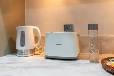 two appliances sitting on top of a table at Chic 1BR Apartment in Downtown Dubai Steps Away from Burj Khalifa & Dubai Mall in Dubai