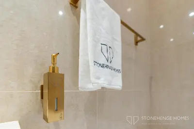 a towel hanging on a towel rack in a bathroom at Chic 1BR Apartment in Downtown Dubai Steps Away from Burj Khalifa & Dubai Mall in Dubai
