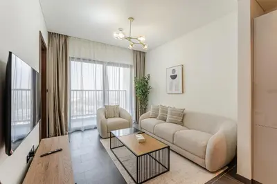 a living room with a couch and a table at HAVN - 2 Bedroom Luxe Stay at The Crest, Sobha in Dubai