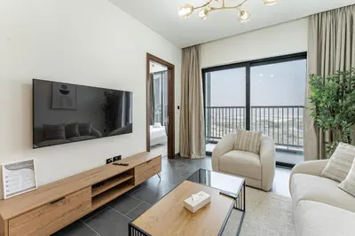 a living room with a tv and a couch at HAVN - 2 Bedroom Luxe Stay at The Crest, Sobha in Dubai