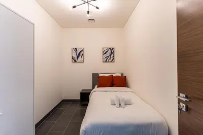 a bedroom with a bed with two pillows on it at HAVN - 2 Bedroom Luxe Stay at The Crest, Sobha in Dubai