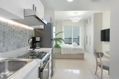 a kitchen with a sink and a stove in a room at Gala Guests - Serene Lakeside Residences Production City in Dubai