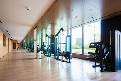 a gym with treadmills and ellipticals in a building at Luxury 1BR in Binghatti Onyx JVC with Pool, Gym & Balcony in Dubai