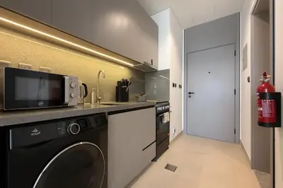 a kitchen with a washer and a dishwasher at Stylish Studio 10 Mins from Dubai Mall Meydan Area in Dubai
