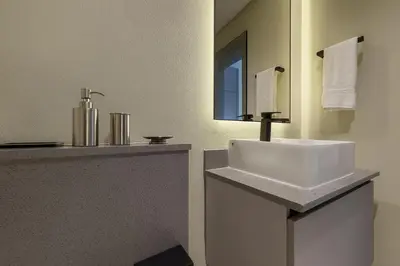a bathroom with a white sink and a mirror at Stylish Studio 10 Mins from Dubai Mall Meydan Area in Dubai