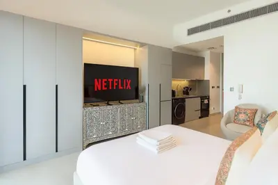a living room with a television on a wall at Stylish Studio 10 Mins from Dubai Mall Meydan Area in Dubai