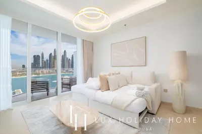 a white bedroom with a bed and a large window at LUX The Palace Residence Suite 2 in Dubai