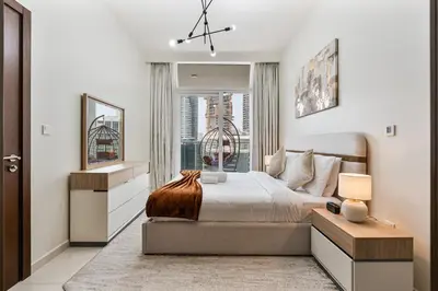a bedroom with a large bed and a window at Luxury 2 Bed with Iconic Burj View, Near Dubai Mall in Dubai