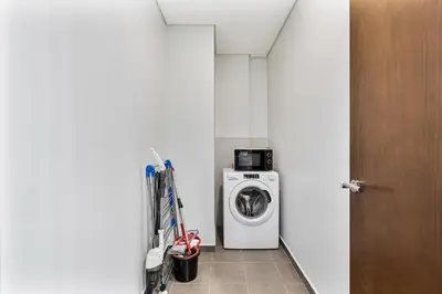 a laundry room with a washer and a washing machine at Luxury 2 Bed with Iconic Burj View, Near Dubai Mall in Dubai