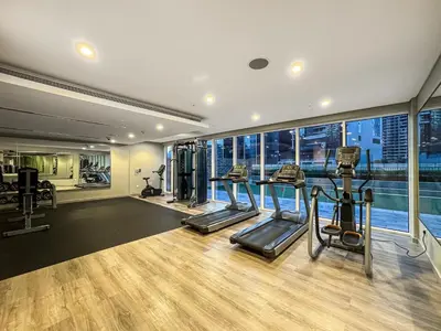 a gym with treadmills and ellipticals in a building at Luxury 2 Bed with Iconic Burj View, Near Dubai Mall in Dubai