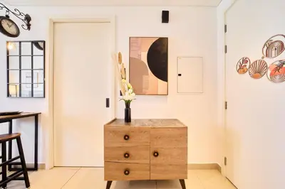 a room with a wooden dresser with flowers on it at Modern 1BR at Collective Dubai Hills Mall Nearby in Dubai