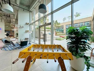 a yellow ping pong table in the middle of a room at Modern 1BR at Collective Dubai Hills Mall Nearby in Dubai