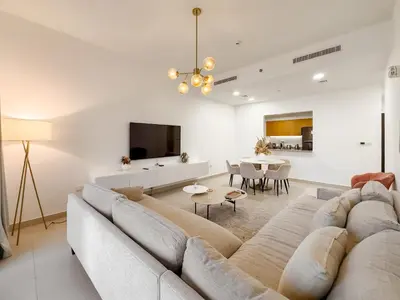 a living room with a couch and a table at Zinnia Luxury 2BHK Bellevue Burj Khalifa View in Dubai