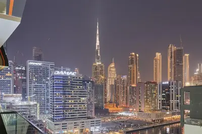 a view of a large city at night at Water Dream with Burj Views Sleeps 4 in Dubai