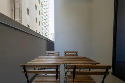 two benches sitting on top of a wooden table at Bright & Stylish 1-Bedroom at Empire Residence in Dubai