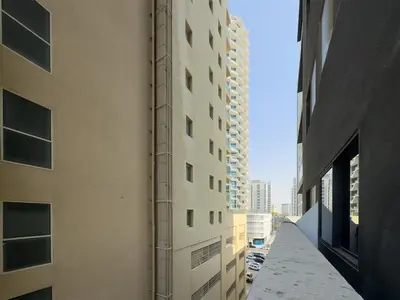 an alley between two tall buildings in a city at Bright & Stylish 1-Bedroom at Empire Residence in Dubai