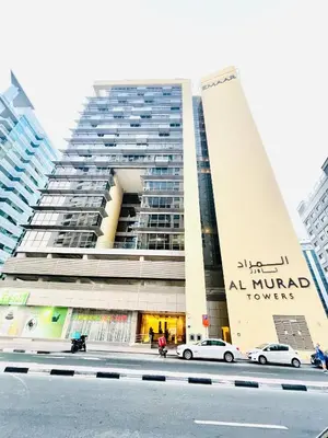 a tall building with cars parked in front of it at Luxurious 1 Bedroom Apartment in Heart of Dubai in Dubai