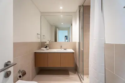 a bathroom with a sink and a mirror at GuestReady - Canal View | 3 Bed | Lagoon Stay in Dubai