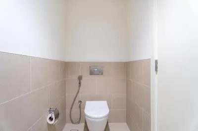 a bathroom with a toilet and a shower at GuestReady - Canal View | 3 Bed | Lagoon Stay in Dubai