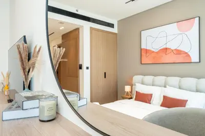 a bedroom with a mirror and a bed at HAVN - Bright & Cozy Studio at Binghatti Azure JVC in Dubai