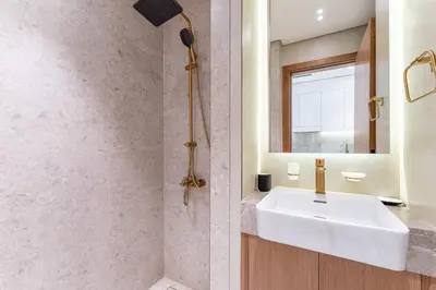 a bathroom with a white sink and a mirror at HAVN - Bright & Cozy Studio at Binghatti Azure JVC in Dubai