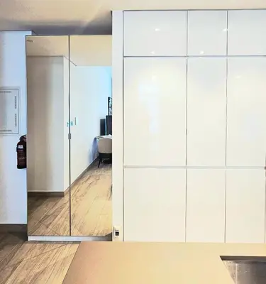 a large white closet with a glass door at Modern New Sea View 1 BR Apartment in Dubai
