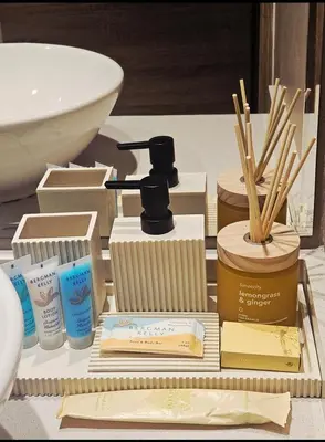 a pile of products sitting on a table in a bathroom at Modern New Sea View 1 BR Apartment in Dubai