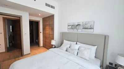 a bedroom with a large white bed with white pillows at Modern New Sea View 1 BR Apartment in Dubai