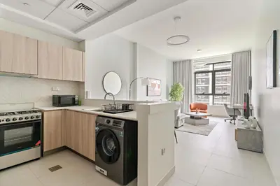 a kitchen with a washer and dryer in a room at VayK - Prestigious 1BR Apartment in Dubai Hills Estate in Dubai