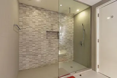 a shower with a glass door in a bathroom at Lux Penthouse 4BR Apartment with Iconic Marina Views in Sadaf2 JBR by Simply Comfort in Dubai