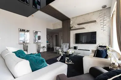 a living room with two white couches and a tv at Lux Penthouse 4BR Apartment with Iconic Marina Views in Sadaf2 JBR by Simply Comfort in Dubai