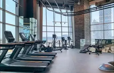 a gym with treadmills and elliptical machines at Water Front, State of the Art Furniture, Burj View sleeps 4 in Dubai